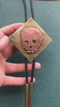 Load and play video in Gallery viewer, Memento Mori Skull Bolo Tie in Copper, Brass and Leather with Sterling Silver Teeth
